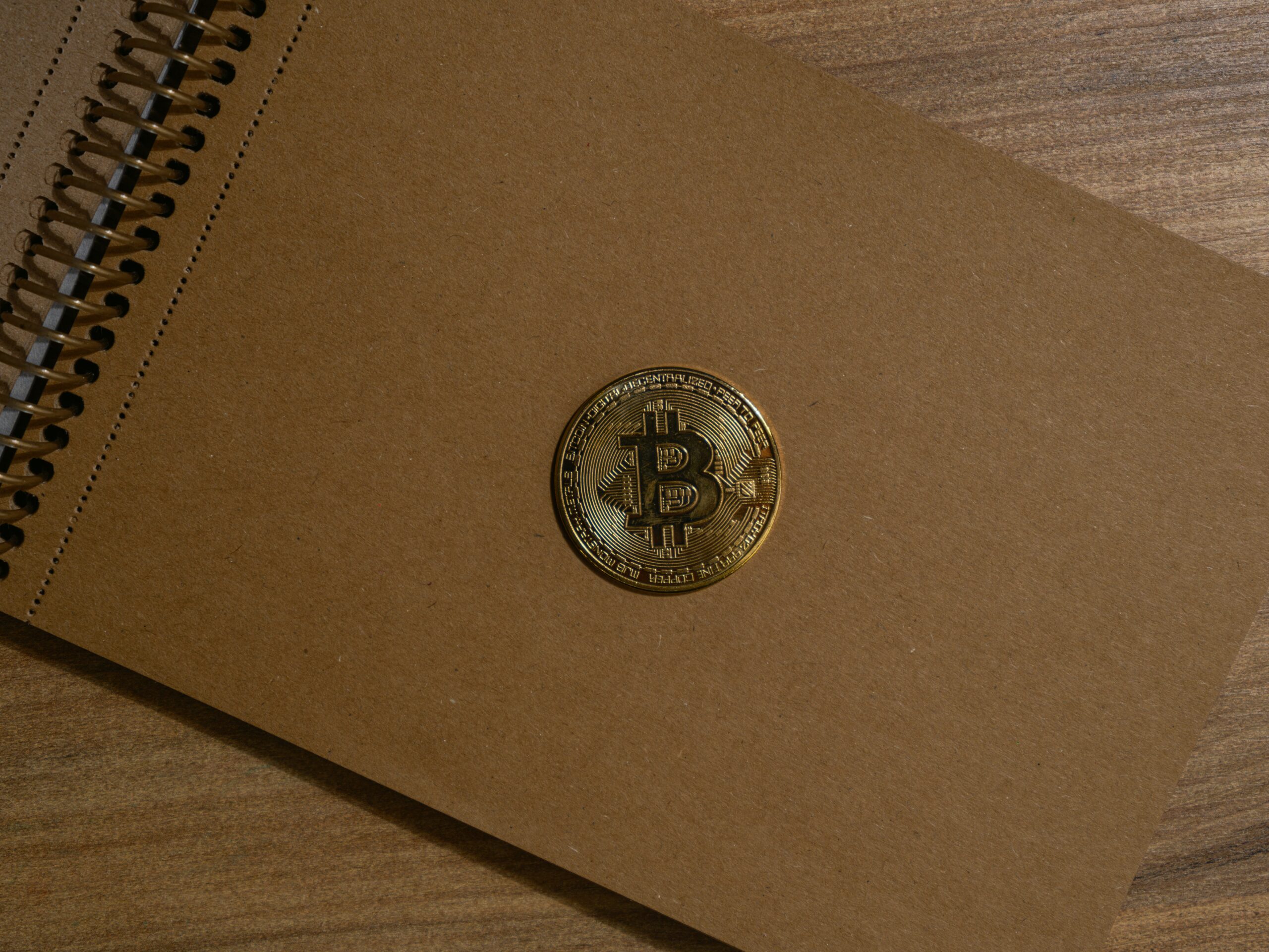 a brown notebook with a bitcoin on it